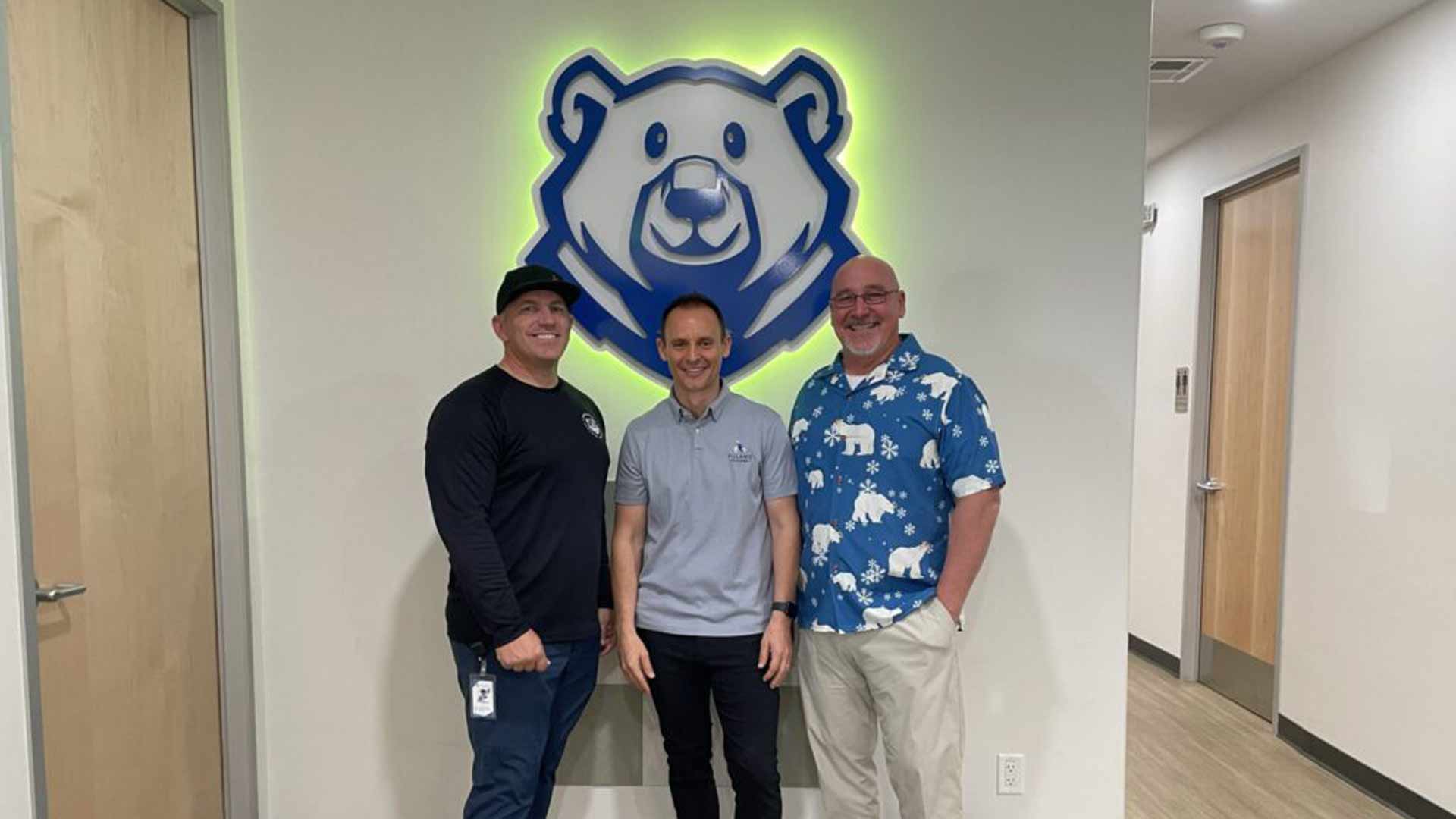 Polaris Academy CFO Brad Broyles, CEO and co-founder Nathan Palmer, and school administrator Aaron Kaczmarek stand in front of the Polaris Academy mascot in Mesa on March 6, 2025. 